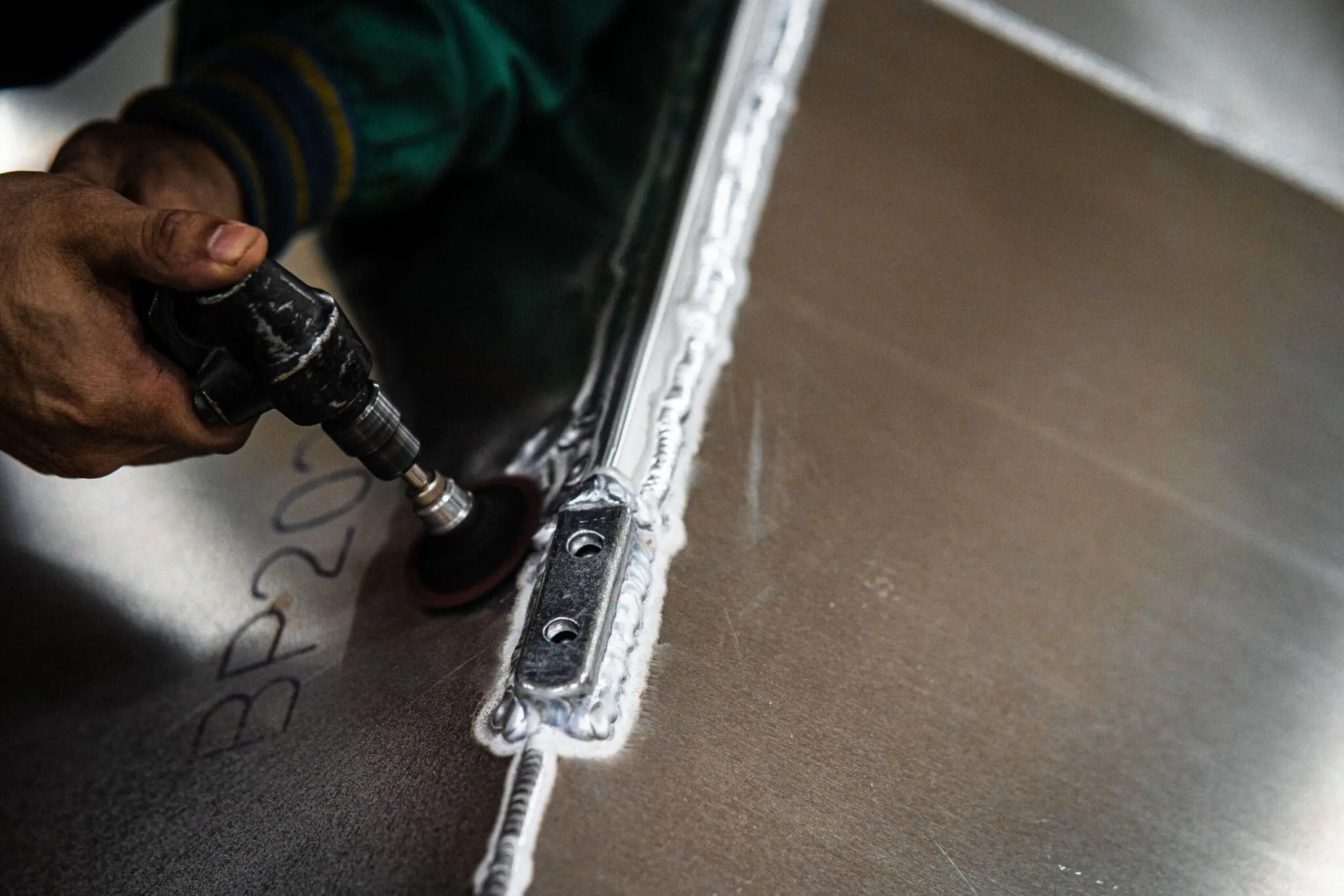 Hands welding an excel boat hull